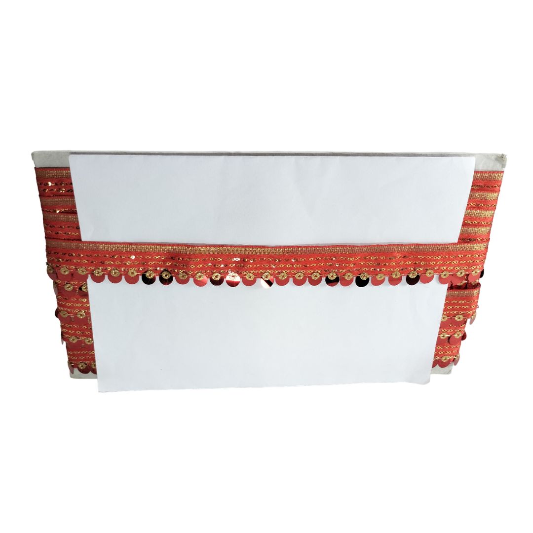 White top with red and gold decorative band on a white background